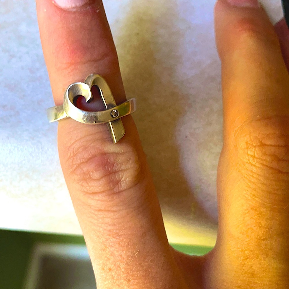 ♥️ shaped Tiffany’s ring (5) with a small single diamond towards the bottom.